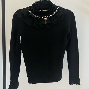 Black top with ruffle neck